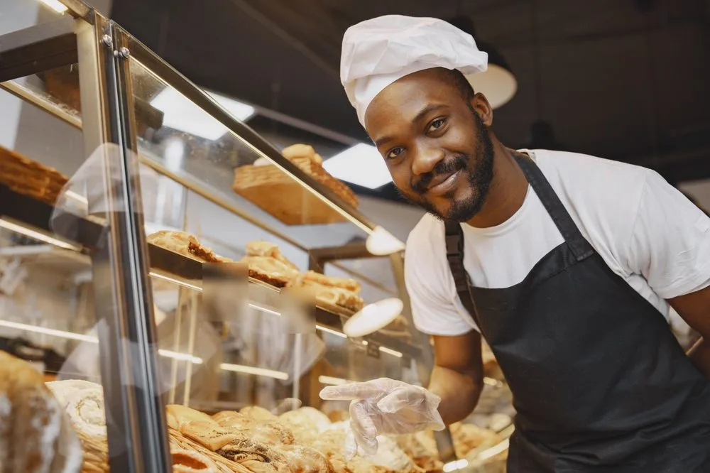 A smiling food seller with his packed snacks